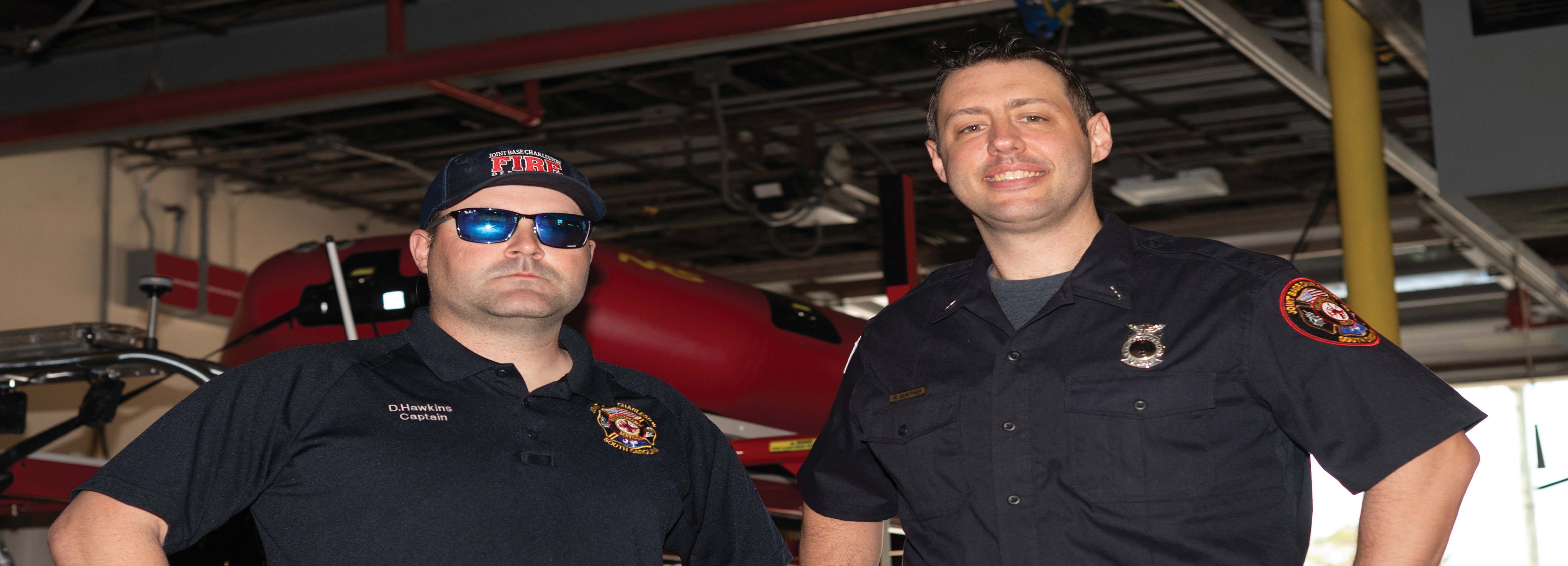 Two Fire Fighters pose for a portrait after an interview.